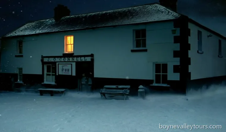 J. O'Connell's pub on the Hill of Skryne at night, lit window glowing above snow-covered ground.